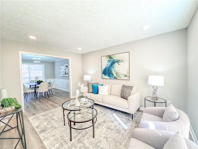 living room with wood-type flooring and a textured ceiling