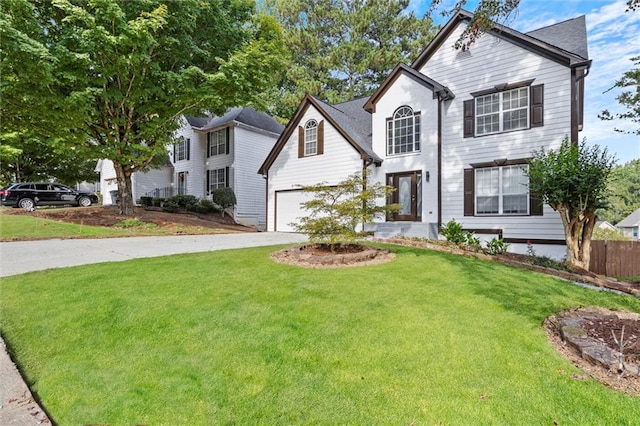 view of front of home with a front yard and a garage