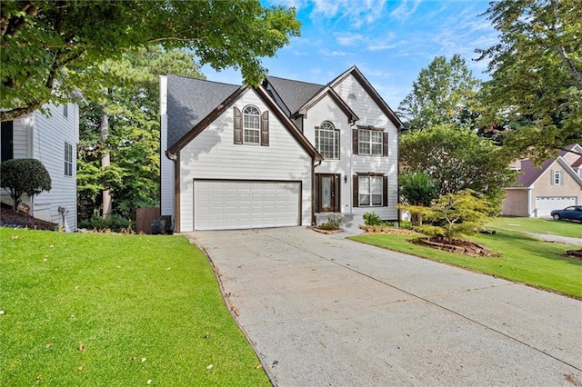 view of front of house with a front yard and a garage