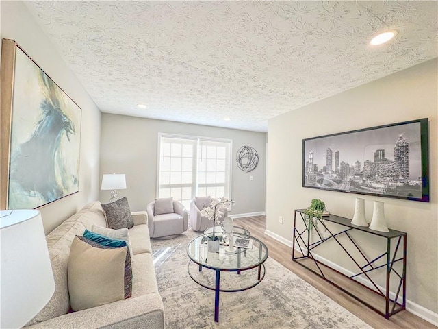 living room with a textured ceiling and hardwood / wood-style flooring