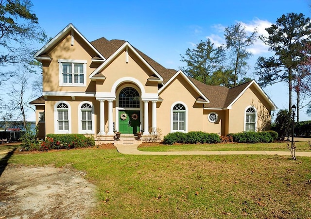 view of front of property with stucco siding and a front lawn