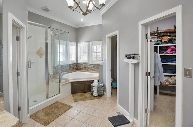 bathroom featuring crown molding, a stall shower, a chandelier, a walk in closet, and a bath