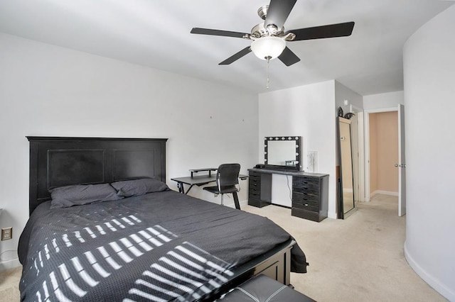 bedroom featuring light carpet, baseboards, and a ceiling fan