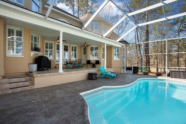 swimming pool with a patio, ceiling fan, and a lanai