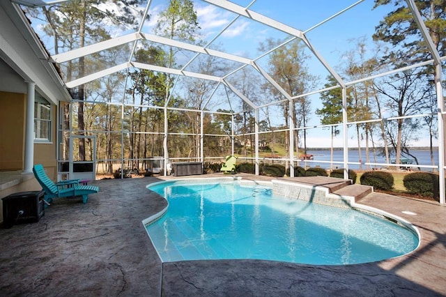 outdoor pool featuring a patio and glass enclosure