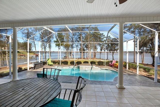 swimming pool with a water view, a patio area, a lanai, and ceiling fan