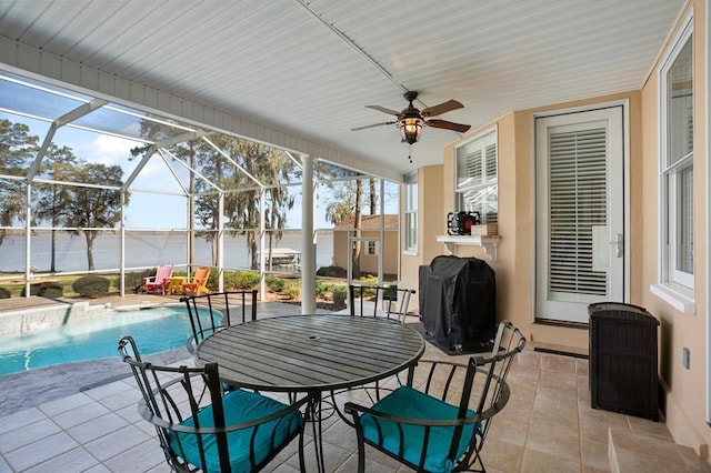 sunroom / solarium featuring ceiling fan