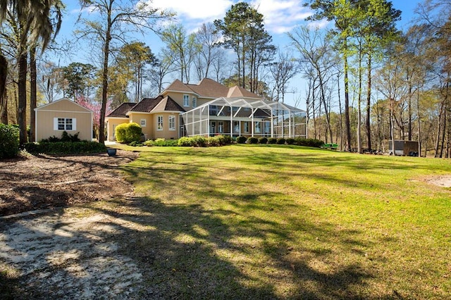 rear view of property featuring a yard and glass enclosure