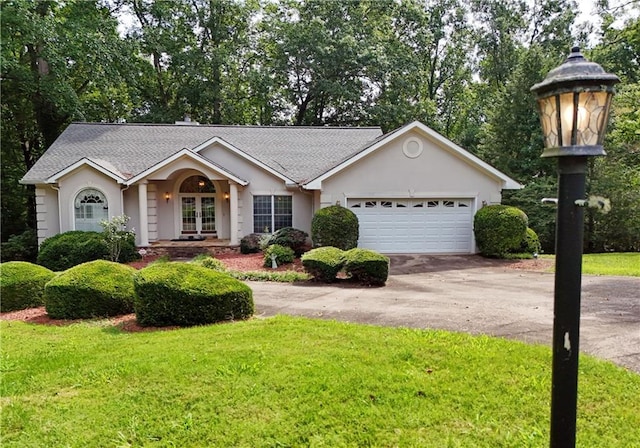 ranch-style house with a garage and a front yard