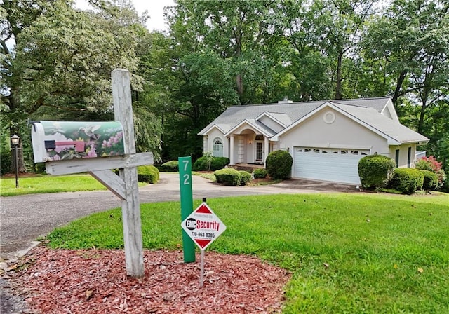 view of front of house featuring a front lawn and a garage