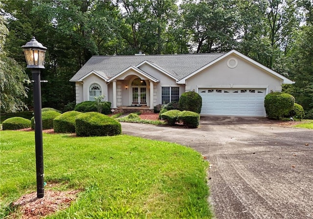 ranch-style home with a front lawn and a garage