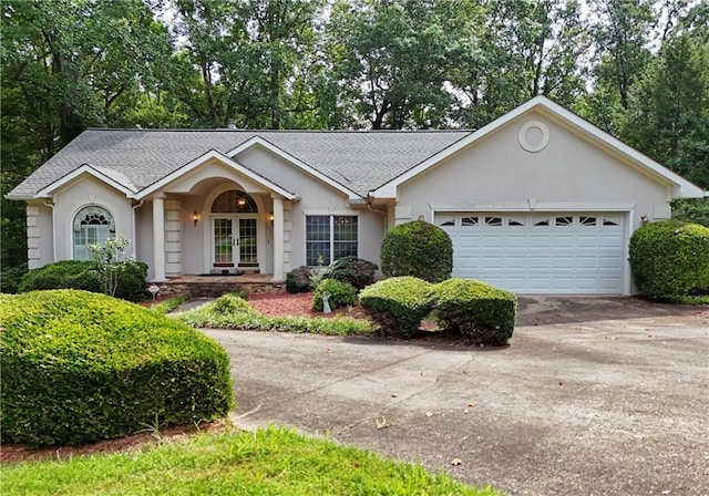 ranch-style home featuring french doors and a garage