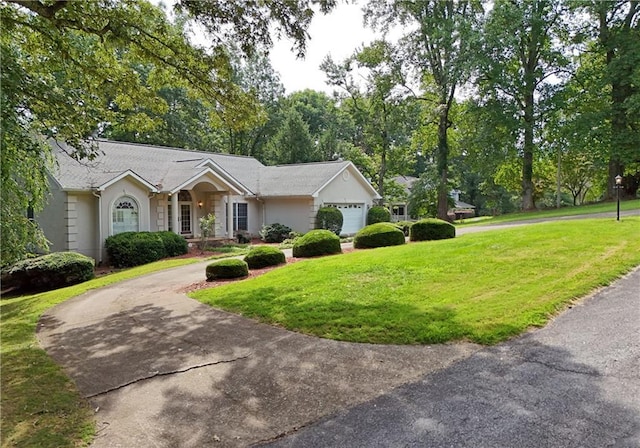 view of front of property with a front yard and a garage