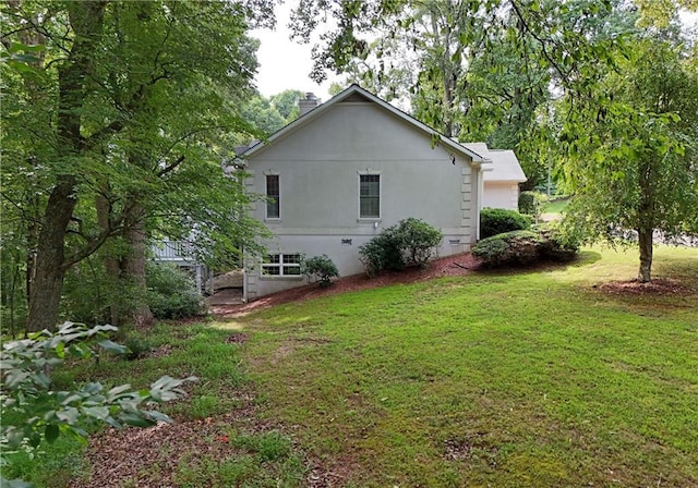 view of home's exterior with a yard