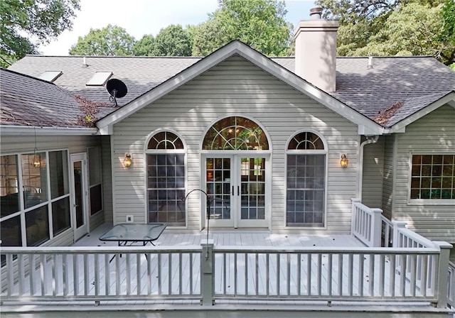 back of property with a deck and french doors