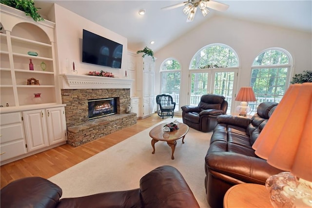 living room with light hardwood / wood-style flooring, a wealth of natural light, lofted ceiling, and ceiling fan