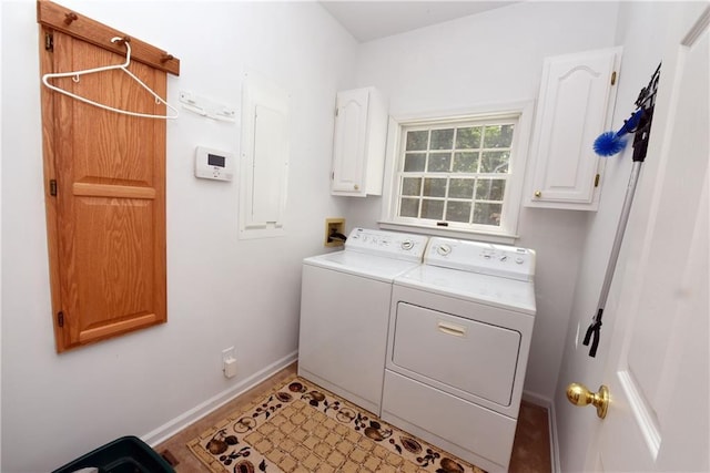 laundry room featuring washer and clothes dryer and cabinets