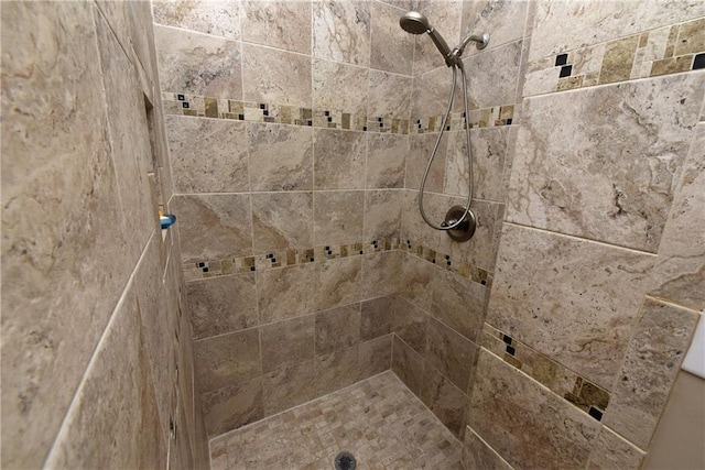 bathroom with tiled shower