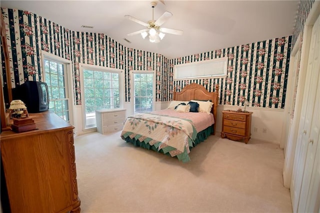 carpeted bedroom with ceiling fan, a closet, access to exterior, and vaulted ceiling