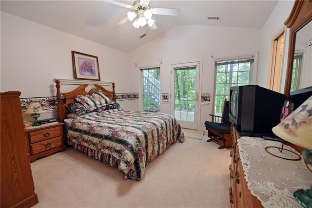 carpeted bedroom featuring access to outside, multiple windows, lofted ceiling, and ceiling fan