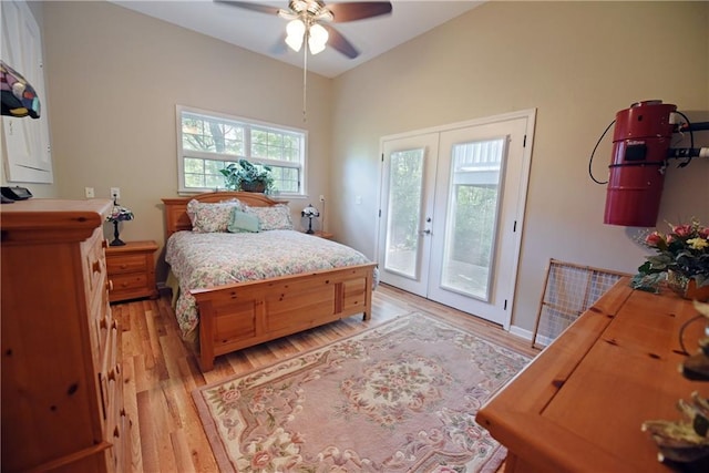 bedroom featuring french doors, vaulted ceiling, ceiling fan, access to exterior, and light wood-type flooring