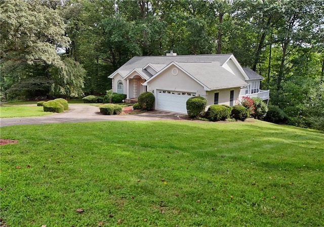 view of front facade with a front yard and a garage