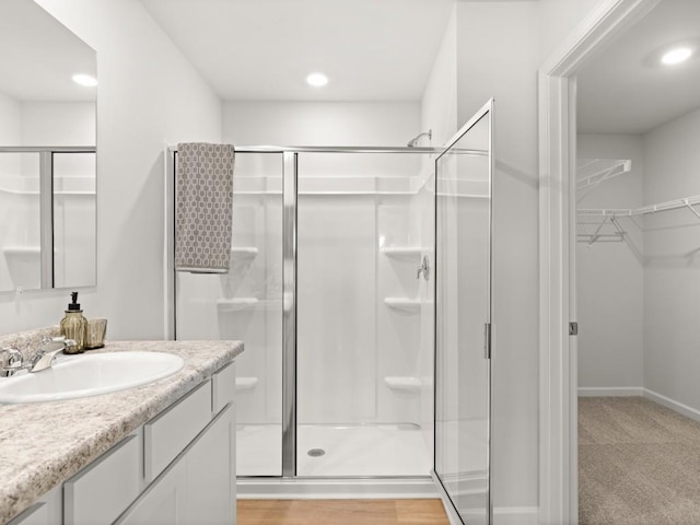 414 Oak View Ln, Dallas, GA 30157 - bathroom with a shower stall, vanity, a spacious closet, and recessed lighting