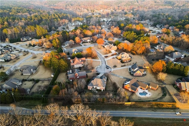 drone / aerial view featuring a residential view and a forest view