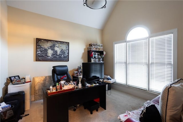 home office with high vaulted ceiling and carpet flooring