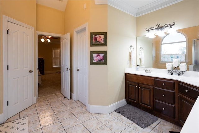 full bath with tile patterned floors, vanity, baseboards, and crown molding