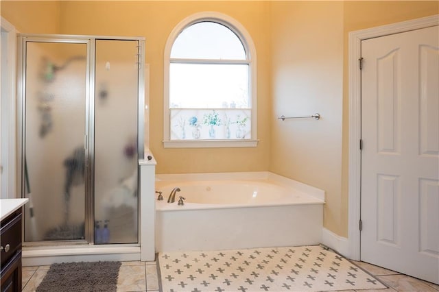 full bathroom featuring a shower stall, a bath, vanity, and plenty of natural light