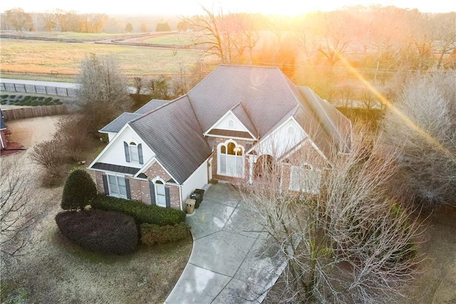 aerial view at dusk featuring a rural view