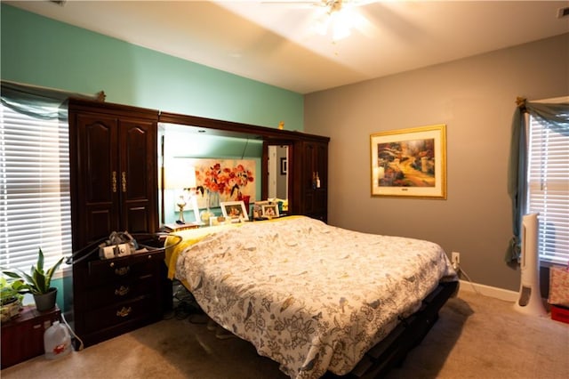 bedroom featuring light colored carpet, a ceiling fan, and visible vents