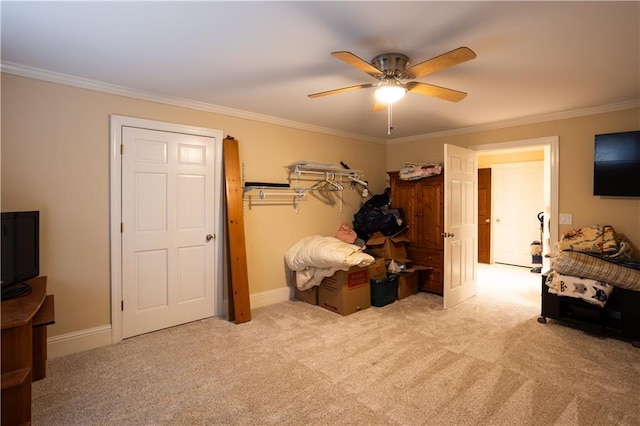 bedroom featuring ceiling fan, baseboards, crown molding, and carpet floors