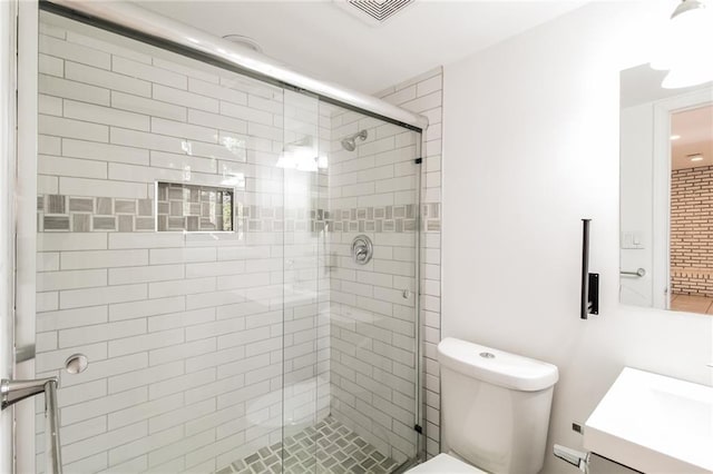 bathroom with visible vents, a shower stall, vanity, and toilet