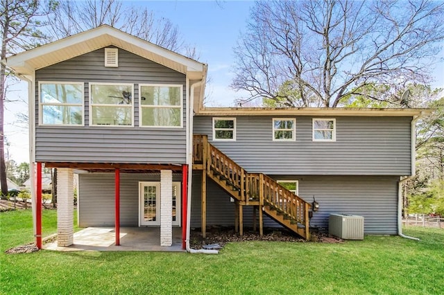 back of property featuring stairs, cooling unit, a patio area, and a lawn