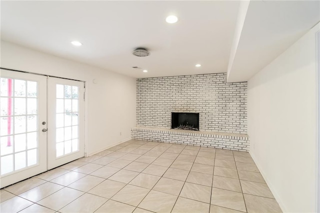 unfurnished living room with light tile patterned flooring, recessed lighting, french doors, and a fireplace