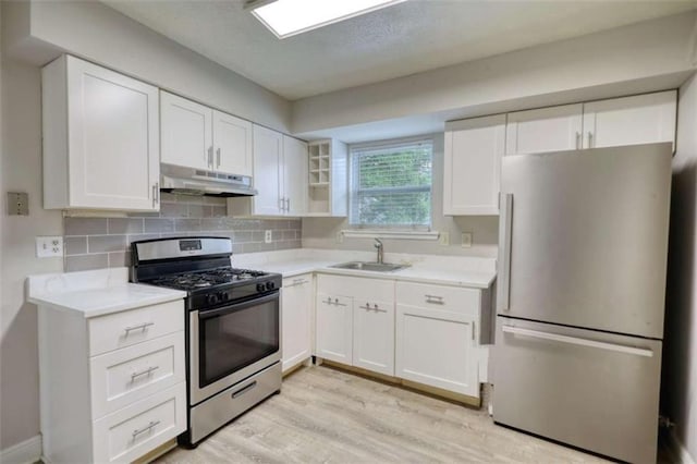 924 Park Gate Pl, Stone Mountain, GA 30083 - kitchen with appliances with stainless steel finishes, under cabinet range hood, a sink, and light countertops