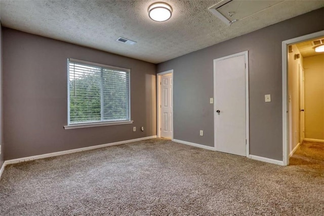 924 Park Gate Pl, Stone Mountain, GA 30083 - unfurnished bedroom featuring carpet, baseboards, a textured ceiling, and attic access