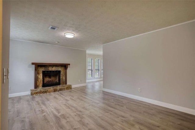 924 Park Gate Pl, Stone Mountain, GA 30083 - unfurnished living room with wood finished floors, ornamental molding, baseboards, a fireplace, and a textured ceiling