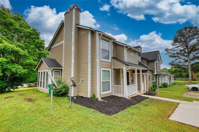 924 Park Gate Pl, Stone Mountain, GA 30083 - view of side of property with a chimney, a yard, covered porch, and a sunroom