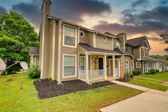 924 Park Gate Pl, Stone Mountain, GA 30083 - view of front of home with covered porch, a chimney, and a front lawn
