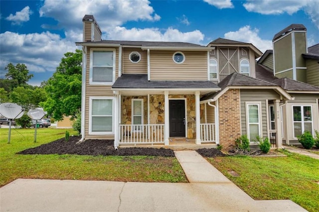924 Park Gate Pl, Stone Mountain, GA 30083 - view of front facade with a porch, a chimney, a front lawn, and stone siding