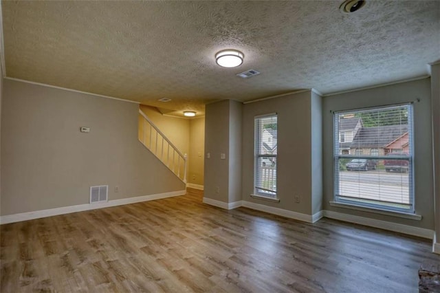 924 Park Gate Pl, Stone Mountain, GA 30083 - empty room with plenty of natural light, wood finished floors, stairway, baseboards, and ornamental molding