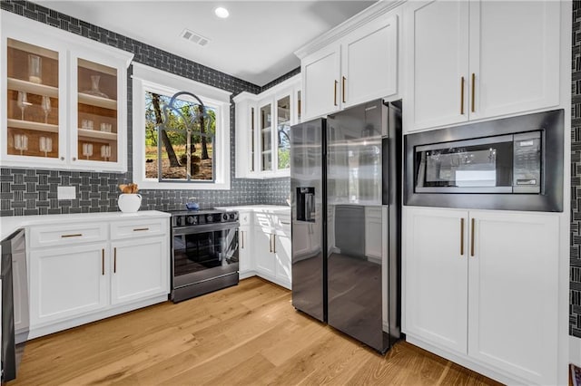 1132 N Edgewater Trl, Toccoa, GA 30577 - kitchen featuring fridge with ice dispenser, electric stove, built in microwave, white cabinets, and decorative backsplash