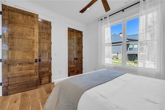 1132 N Edgewater Trl, Toccoa, GA 30577 - bedroom featuring wood finished floors, multiple windows, and a ceiling fan