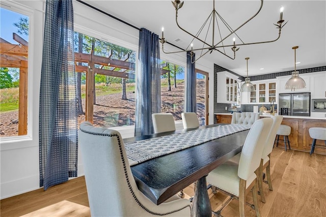 1132 N Edgewater Trl, Toccoa, GA 30577 - dining room with light wood-style floors and a chandelier