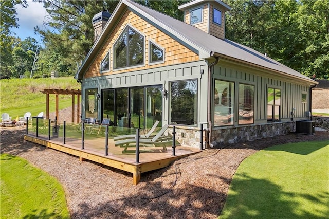 1132 N Edgewater Trl, Toccoa, GA 30577 - view of property exterior with a chimney, a wooden deck, board and batten siding, stone siding, and a metal roof