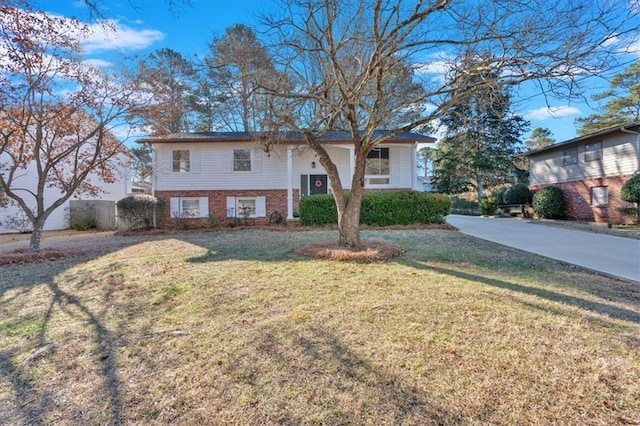 bi-level home with a front lawn