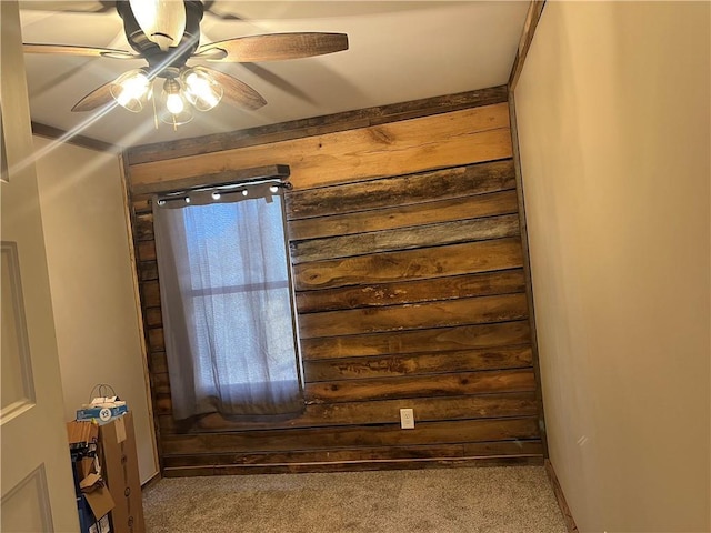 carpeted spare room featuring a ceiling fan